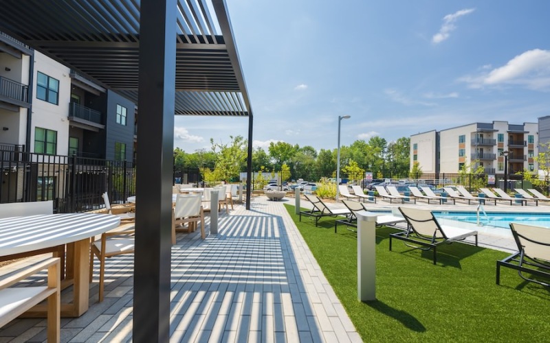 Outdoor lounge with tables and chairs at Bowery West pet-friendly apartments and townhomes in Charlotte, NC