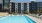 swimming pool in a courtyard with a building in the background